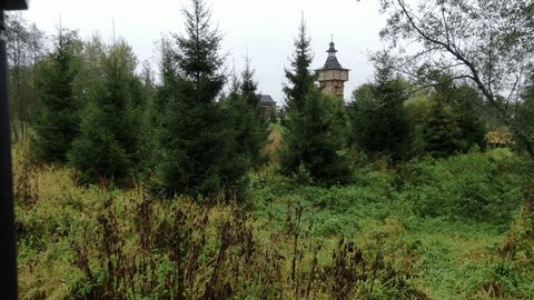 Forward Drone Flight toward Wooden Buildings