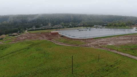 Forward Drone Flight over Field toward Wooden