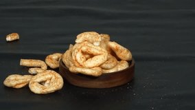 Spicy crackers are poured and scattered onto a dark background, creating a dynamic snack arrangement. Great for snack ads and food motion visuals. - Powered by Shutterstock - Get 15% off with code: PIKWIZARD15