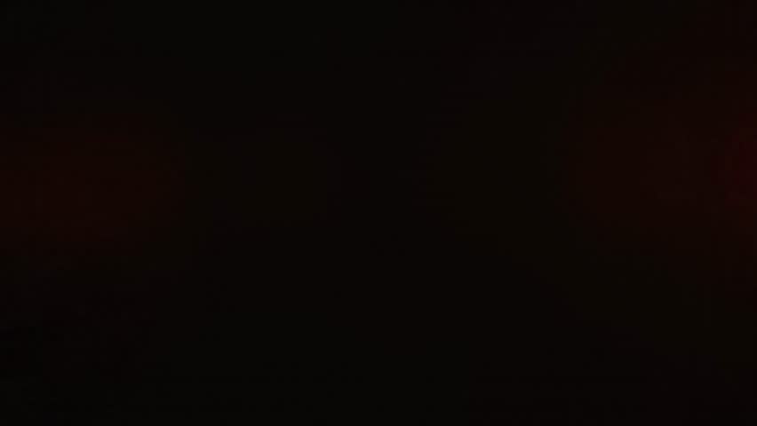 Vivid red smoke plume drifting against a dark background