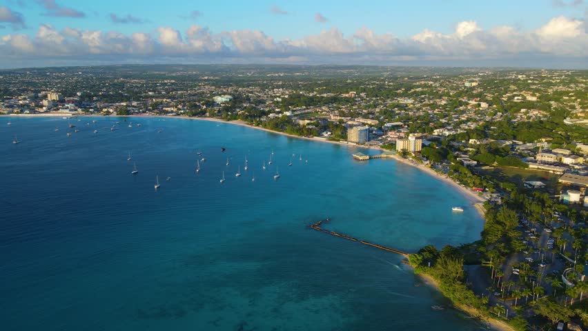 Pebbles Beach aerial view at sunset at Carlisle Bay in city of Bridgetown, Saint Michael, Barbados. This coast belongs to Bridgetown and Garrison UNESCO World Heritage Site. 