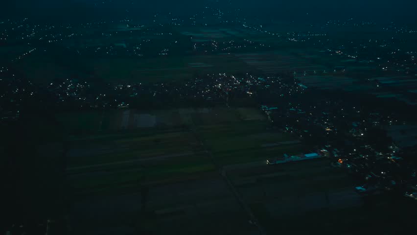 Wide Aerial Drone View of Urban City Lights and Residential Areas at Night