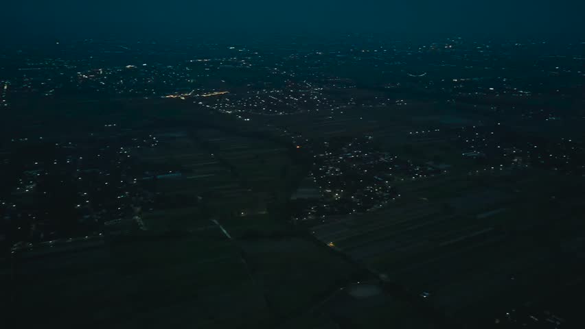 Aerial Drone View of Vast Urban City Lights Landscape During Nighttime Atmosphere