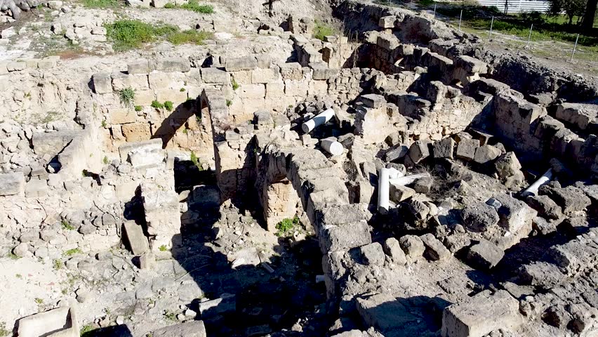 At this archaeological site, various stone structures are visible, showcasing remnants of ancient civilization. The area is rich in history, with intriguing details in the ruins.
