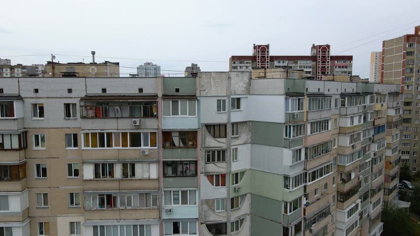 Aerial view of old soviet architecture buildings, in a poor ghetto district of Kyiv, overcast day, in Kiev, Ukraine - tracking, drone shot 4k