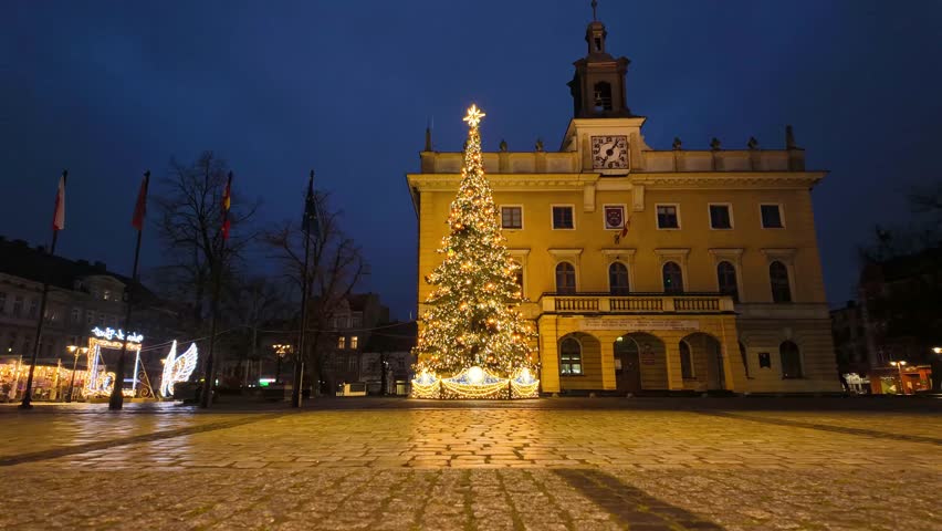 Christmas tree on market square in Ostrow Wielkopolski hyperlapse in front of town hall at night illuminated square