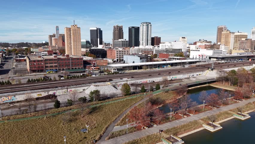 Stunning 4K drone footage of Railroad Park in Birmingham, AL, showcasing green spaces and urban skyline. Ideal for city life, nature, or travel projects.