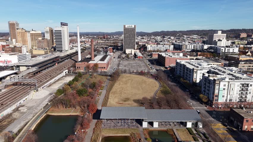 Stunning 4K drone footage of Railroad Park in Birmingham, AL, showcasing green spaces and urban skyline. Ideal for city life, nature, or travel projects.