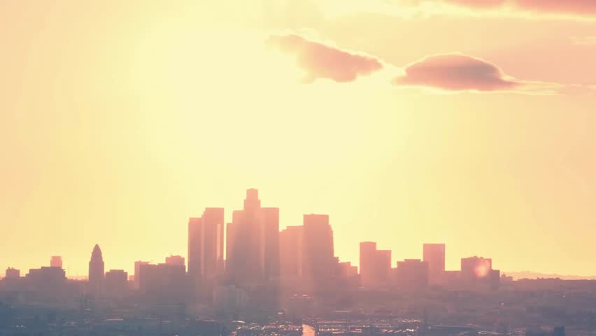 Sunset timelapse with a huge Sun above the city end of the hot summer day Time lapse beautiful sunrise over mountain yellow cloudscape with large sun