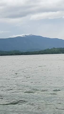 a journey across the lake with green mountains in the distance