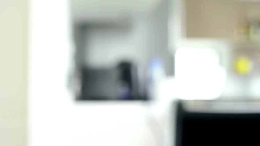 Man on sofa flipping through TV channels with remote control in hand. sitting on sofa with remote control and watching programs on TV. holding TV remote control in hands sitting on couch.