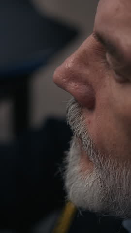 Vertical of three diverse security guards on night duty working together in dim control room monitoring multiple screens and coordinating safety operations
