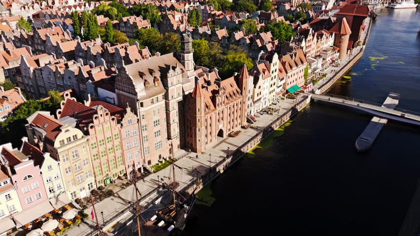 Early morning calm reveals Gdansk old town promenade beside Motlawa