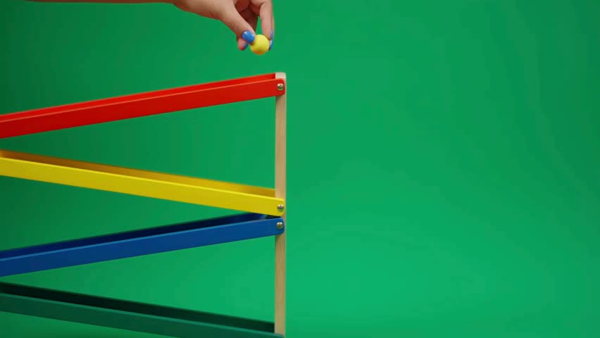Ball rolling down colorful wooden track in 4K, capturing smooth motion, playful physics concept, vibrant educational toy design, and engaging kinetic movement for creative learning visuals.
