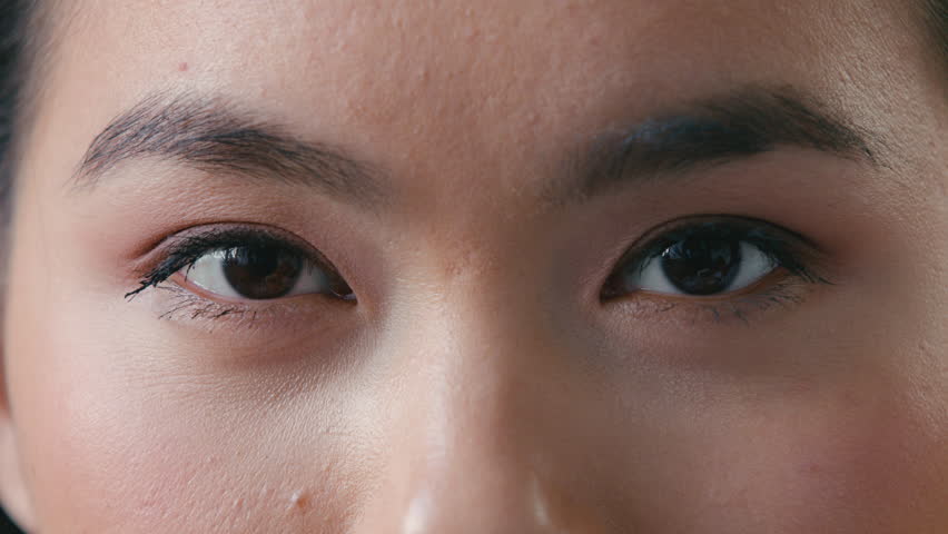 Close up Asian woman sad dark eyes looking at camera Korean Japanese Chinese girl upset female gaze long eyelashes good vision eyesight details human eye sight laser surgery ophthalmology medicine
