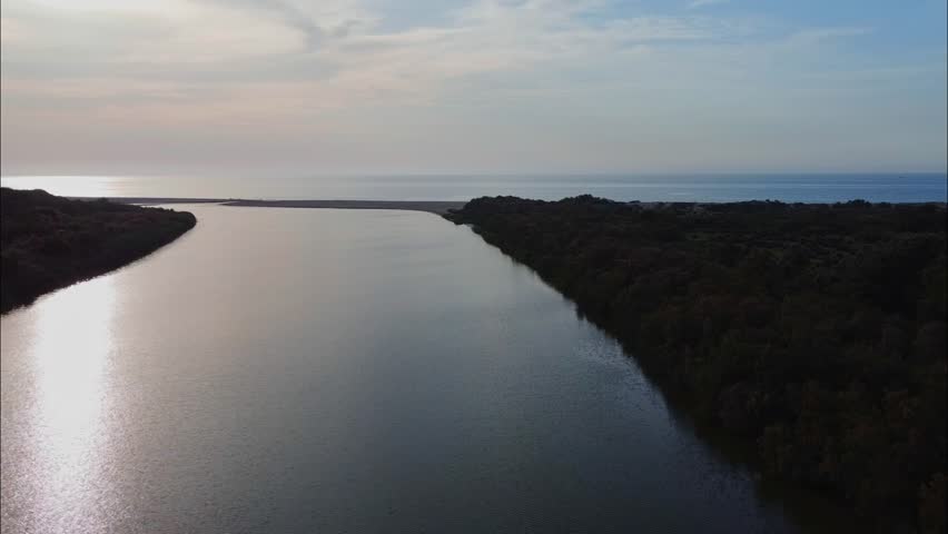 Aerial View of river, Beautiful Aerial View of African Jungles forest and River, Landscape in aerial drone shot. Adove calm tranquil river in Jijel Algeria North Africa, Rivers and green fores trees. river, forest, aerial, water, nature, view, tree, lake, algeria, africa, african, landscape, environment, stream, travel, jungles, background, natural, flow, outdoor, african jungles, mountain, green, beautiful, above, wild, hill, valley, scenic, top, tropical, park, canyon, flowing, plant, simple, blue, sea, sky, wave, grass, wet, waterfall, trees, reflection, clouds, jijel, spring, summer.