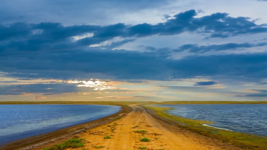 small lakes in prairie at the dramatic sunset, evening natural time lapse scene