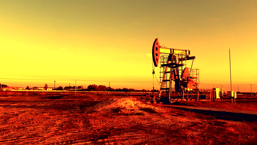 Crude pump jack on sunrise in oil field. Oil Pump Jack Operates on Beautiful Sunset at Oil Field in Industrial Area. Oil drill rig, drilling derrick in oilfield. Crude petroleum industry. 