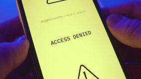 Close up on phone alert or message announcing device is hacked and access denied. Person holding mobile phone receives notification warning of malware or virus locked system and breached its security - Powered by Shutterstock - Get 15% off with code: PIKWIZARD15