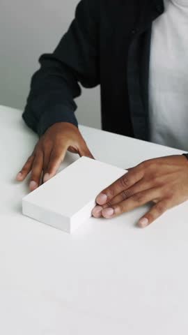 Person unboxing a new smartphone in 4K, showing hands-on interaction, modern device reveal, detailed packaging, and visually engaging technology and lifestyle content creation visuals.