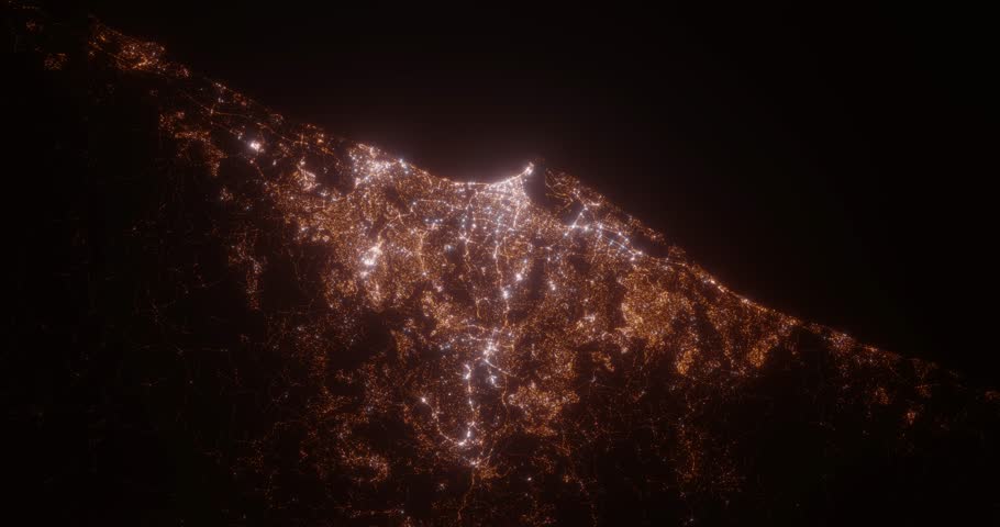 Durban (South Africa) top view at night. View on modern city from satellite. Camera is zooming in, rotating counterclockwise. Vertical video. The north is on the left side