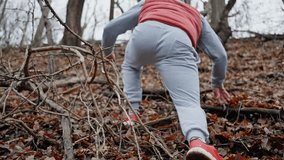 Obstacle Course Through Forest Floor, Individual Ascends Through Tangled Foliage And Damp Leaf Litter, Man Struggles Upward Through Tangled Undergrowth And Moist Fallen Leaves With Determination - Powered by Shutterstock - Get 15% off with code: PIKWIZARD15