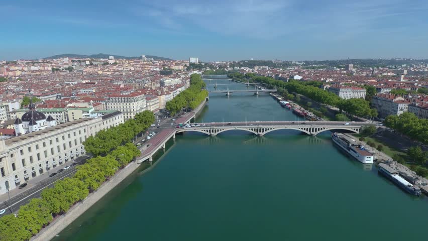 Aerial drone view over Lyon city center – River, bridge, and buildings below