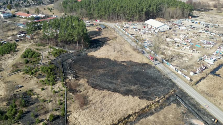 Springtime Burnt Field with Fire Crew and Recovery Signs