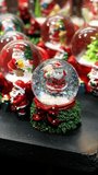 Close-up of a Christmas snow globe with a Santa Claus figure inside, creating a festive holiday atmosphere. - Powered by Shutterstock - Get 15% off with code: PIKWIZARD15