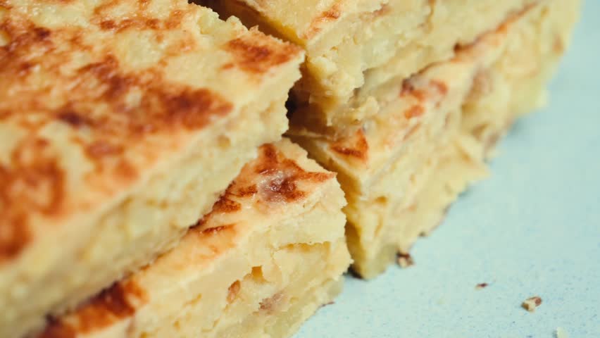 Spanish tortilla is a dish made from beaten and fried eggs, potatoes, and onions. It is a symbol of Spanish cuisine. High quality 4k footage