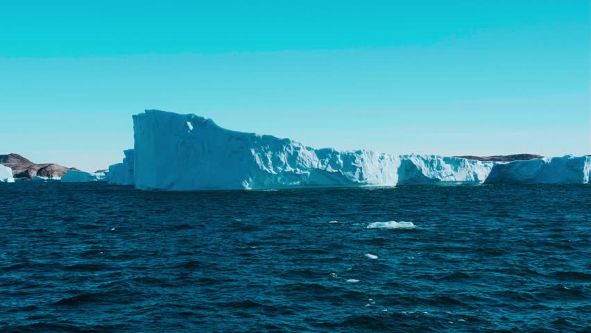 Towering ice cliff in sunset Antarctic landscape, toward colorful sky. Breathtaking scene of an Antarctica iceberg. Arctic environment preserve of ice. Huge high glacier at polar nature.
