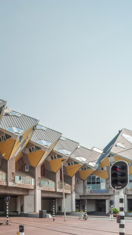 Hyperlapse of Cube House (Kubuswoningen) in Rotterdam. Unique yellow cube-shaped houses showcasing innovative architecture amid the cityscape timelapse. Blue sky and urban vibrancy. Netherlands