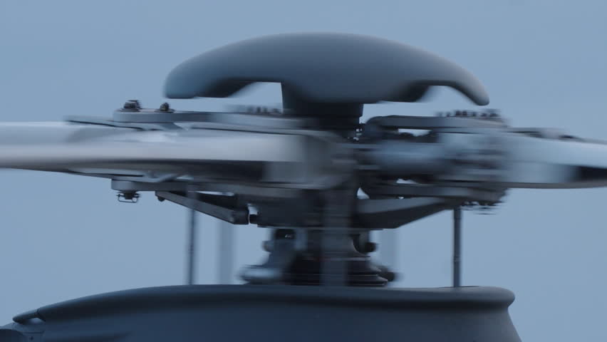 Helicopter main rotor spinning at high speed with visible motion blur highlighting aviation technology and mechanical power in flight operation