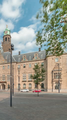 Hyperlapse of Rotterdam City Hall (Stadhuis van Rotterdam) at Coolsingel. One of the few historic buildings in the city center timelapse. Traffic and people on the street, cloudy blue sky. Netherlands