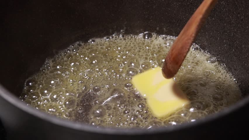 Melting Cube of Butter in Pot with Wooden Spoon – Cooking Preparation
