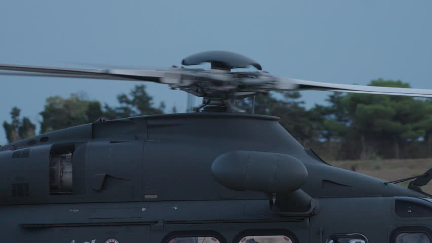 Close view of helicopter main rotor spinning at high speed illustrating power and motion during flight operation
