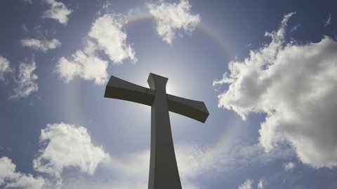 Crucifix Cross with Halo Sun Flare Timelapse with Moving White Clouds against Blue Sky 1920x1080