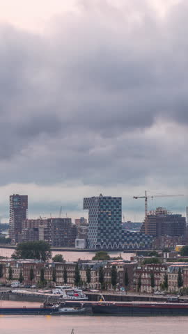Panoramic aerial day to night transition timelapse of Katendrecht peninsula and Maashaven harbour in Rotterdam, The Netherlands. City skyline modern skyscrapers and traditional Dutch waterfront houses