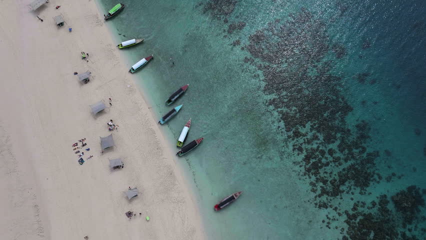 Aerial view of Nakupenda island, sandbank in ocean, white sand, boats, yachts, blue sea during low tide at sunny summer day in Zanzibar. Top view of sand spit and clear water.