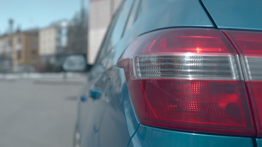 Person Opening Car Trunk In City Scene, Winter Scene With Vehicle And Pedestrian In Urban Environment. Media