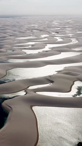 Sunset at sand dunes and rain water lagoons at northeast brazilian paradise. World travel destinations. Tropical scenery. Lencois Maranhenses Maranhao Brazil.