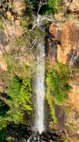 Waterfall at scenic gorge canyon. Peaking waterfall landscape. Nature background. Waterfalls cascade at gorge canyons background. Geologycal formation ecosystem. Waterfalls landscape.