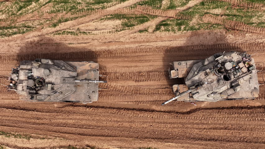 Aerial Top Down Merkava Tanks Gaza Border

Drone footage showing two IDF Merkava tanks from a top down aerial view near the Gaza border in 2024.

