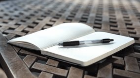 Close-Up of  Blank Notebook Page Turning in Breeze - Powered by Shutterstock - Get 15% off with code: PIKWIZARD15