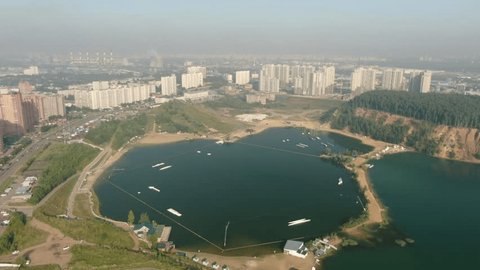 Aerial Backward Flight over Lakeside City