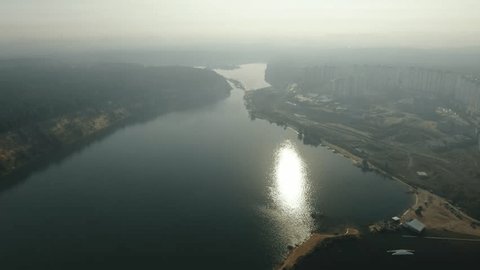 Aerial Backward Movement over Lakeside Landscape