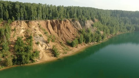 Drone Flying Sideways along Forested Cliff