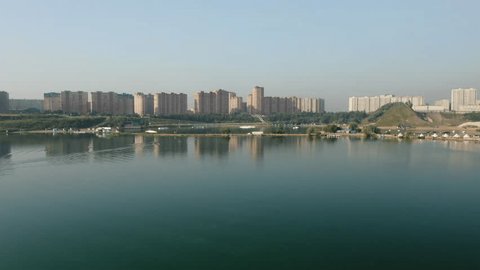 Slow Aerial Approach across Lake toward City