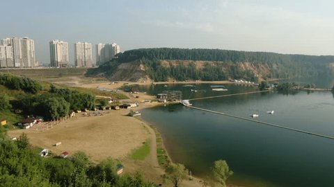 Drone Descending over Lakeside Beach Forest Cliffs