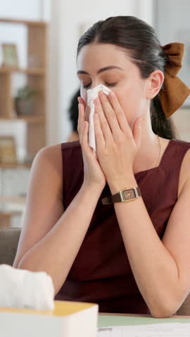 Sick woman, typing or blowing nose with tissue in office for illness, disease or virus. Female person, sneeze or mucus with hayfever, infection or sinus for allergy season or influenza in workplace